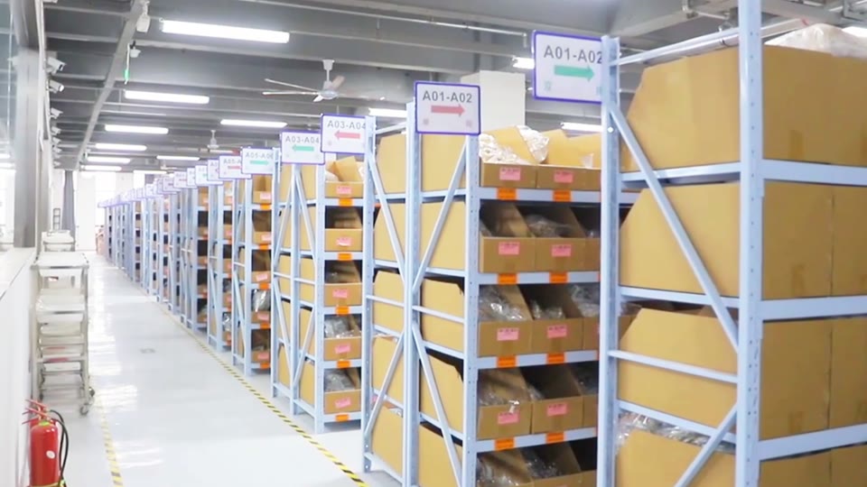 Shelving and boxes in the warehouse aisle.