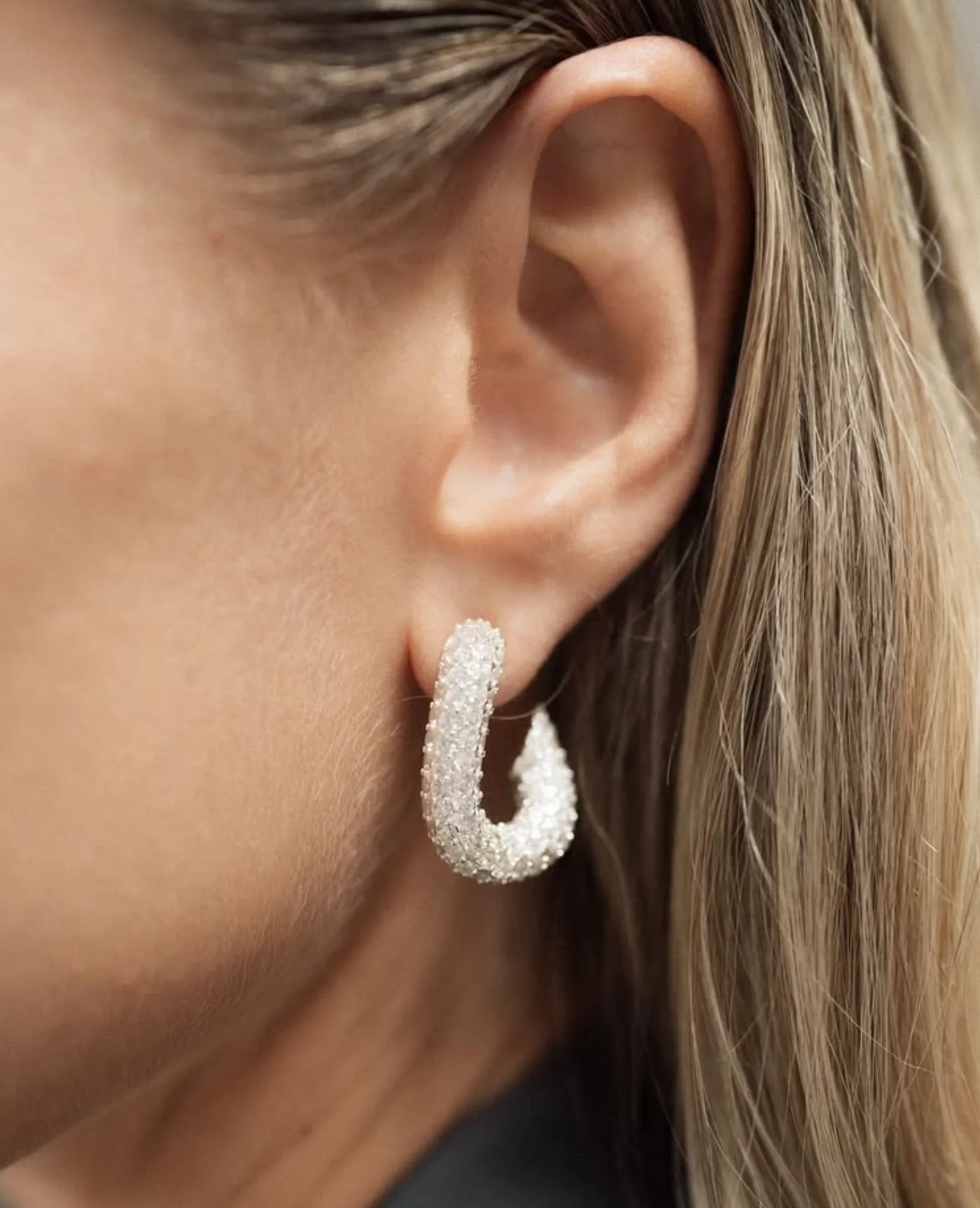 Hoop earring worn in a custom jewelry case